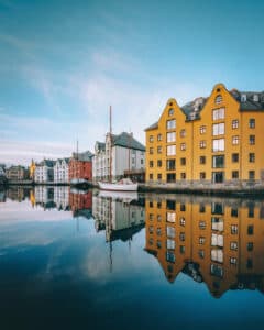 Buildings By Lake Against Sky In City